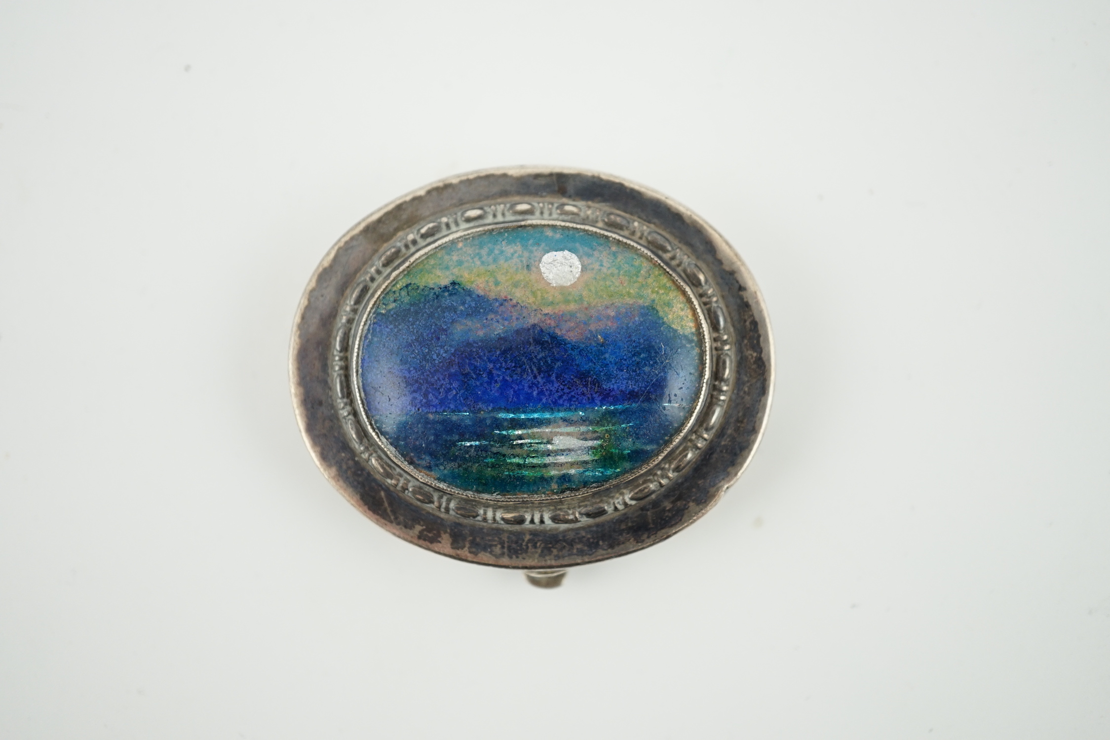 A George V Arts & Crafts Liberty & Co silver and enamel oval pill box, with hinged cover, Birmingham, 1929